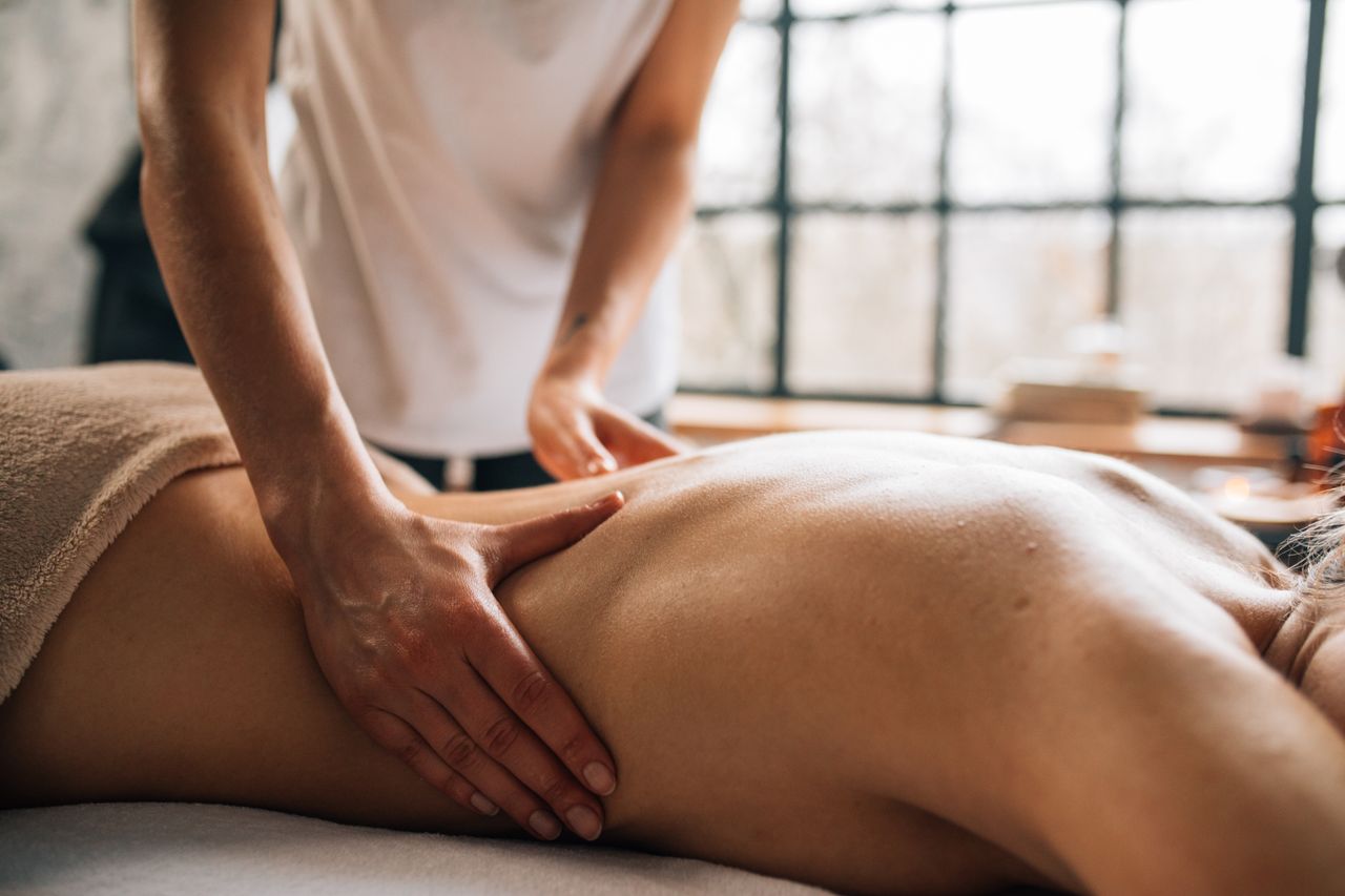 Home Experience relaxation with a full body massage in a serene indoor spa environment.